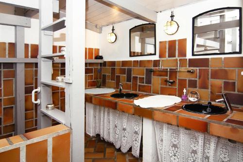 a bathroom with two sinks and two mirrors at Holiday home in Medelby in Medelby