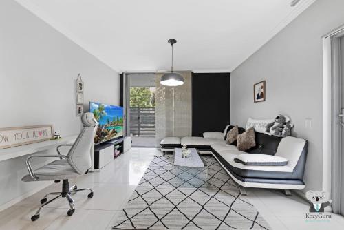 a living room with a couch and a chair at KozyGuru | Ryde | Cosy 2Bed Apt | Free Parking in Sydney