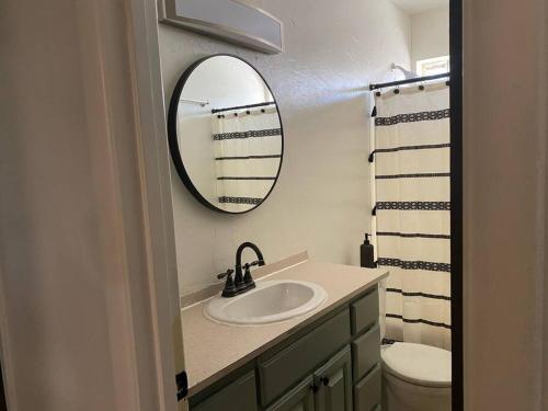 a bathroom with a sink and a mirror at 3BR 2min from I-40,near DT, 21 min Palo Duro in Amarillo