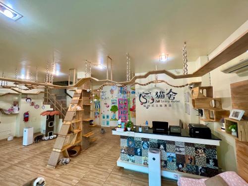 a room with a play room with a wooden ladder at Cat Story Hotel in Patong Beach