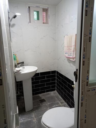 a small bathroom with a sink and a toilet at Jemulpo house - Foreigner Only in Incheon