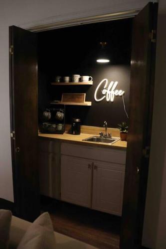 a kitchen with a sink and a sign on the wall at By HWY, 3/2 , sleeps large group Palo Duro Fun in Amarillo