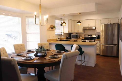 a kitchen with a wooden table and chairs and a dining room at By HWY, 3/2 , sleeps large group Palo Duro Fun in Amarillo