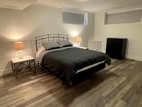 a bedroom with a bed and two tables and two lamps at Escape to Spring Gate Estate in Victoria