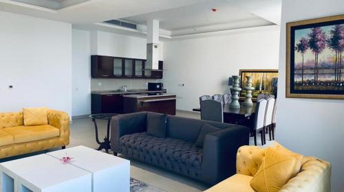 a living room with a couch and a table at One Constitution Avenue by Goldfinch in Islamabad