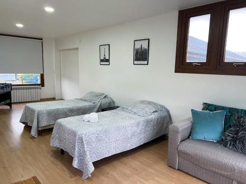a living room with two beds and a couch at Increible Casa ideal Familias in Ushuaia