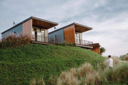 a house on top of a grassy hill at The Sunnery Ville in Lom Kao