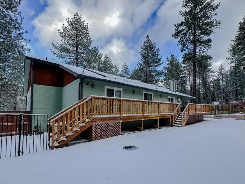 a house with a deck in the snow at Sky Lodge in Wrightwood