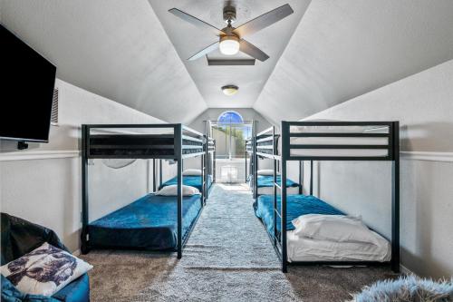 two bunk beds in a room with a ceiling fan at Southwestern Style 4 Bedroom Nampa Home Sleeps 16! in Nampa