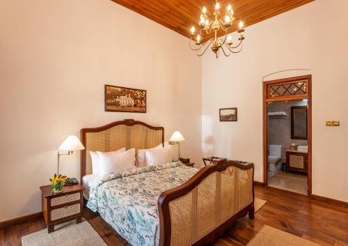 a bedroom with a bed and a chandelier at W15 Lake Gregory in Nuwara Eliya