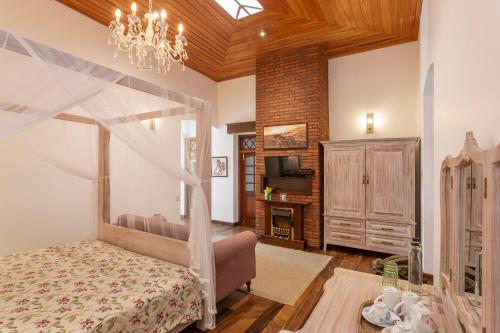 a bedroom with a canopy bed and a fireplace at W15 Lake Gregory in Nuwara Eliya