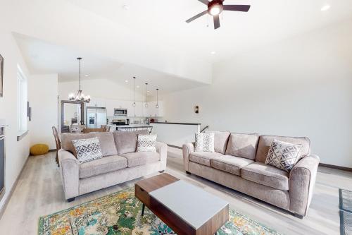 a living room with two couches and a table at Spanish Peaks 1 in Belgrade