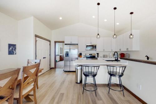 a kitchen with white cabinets and a table and chairs at Spanish Peaks 1 in Belgrade