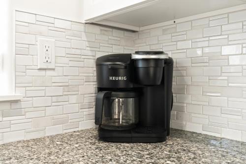 a coffee maker sitting on top of a counter at Caldwell Ruby Tuesday! 60's Inspired comfort 3B2B in Caldwell