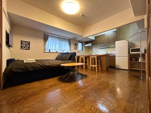 a living room with a bed and a kitchen at nestay apartment tokyo akihabara in Tokyo