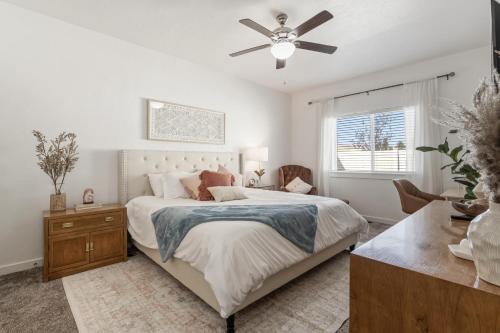 a bedroom with a bed and a ceiling fan at The Bella! West Nampa Private 3 Bedroom Home in Nampa