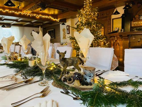 a table with christmas decorations on a white table cloth at Hotel Marienhof- Erstes Motorradhotel in Fliess! in Fliess