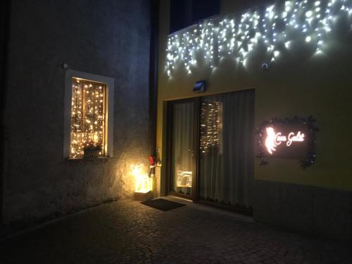 a building with christmas lights on the side of it at Casa Galèt in Tirano