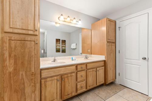 a bathroom with a sink and a mirror at The Oasis at Orange Beach 2203 in Orange Beach