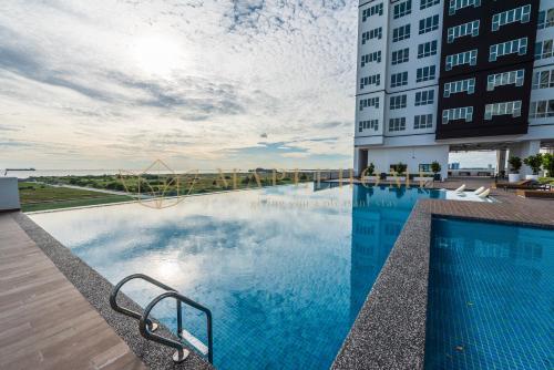 a swimming pool on the side of a building at Amber Cove Premier Suites Melaka in Melaka