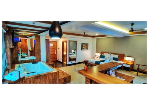 a large living room with a large jacuzzi tub at Chandys Windy Woods Munnar in Munnar