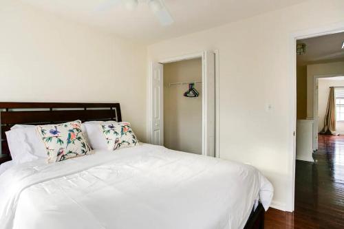 a white bed with pillows in a white bedroom at Beautiful Townhome in Sterling