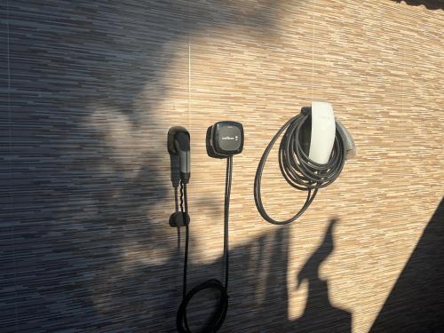 a shadow of a person and a phone on a wall at Villa del Sol in Málaga