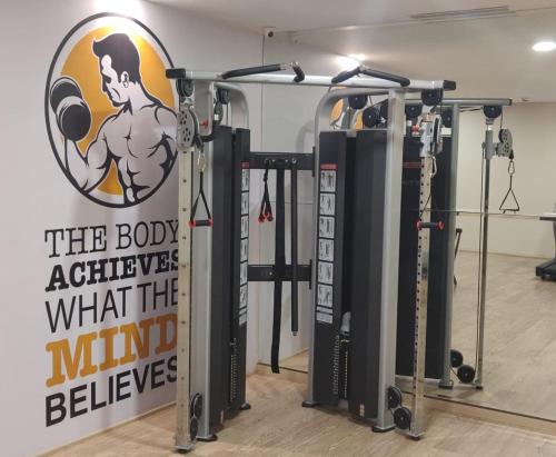 a gym with a sign that says the body achieve what the mind believes at Mirage Hotel, Mumbai International Airport in Mumbai