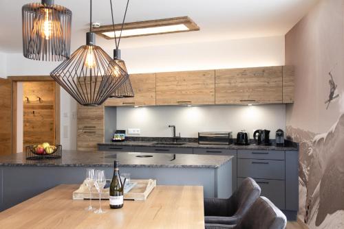a kitchen with a wooden table and a dining room at AvenidA Style Appartements by Alpin Rentals - incl Summercard in Kaprun
