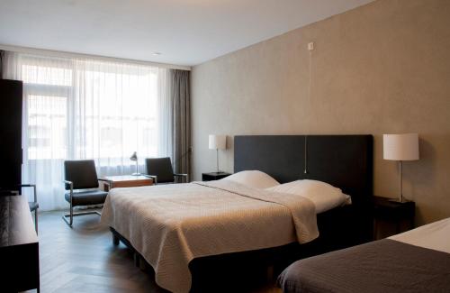 Postel nebo postele na pokoji v ubytování Hotel Mayflower
