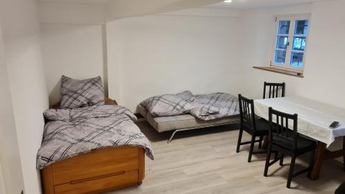 a bedroom with a bed and a table and chairs at Ramsbacher Ferienwohnung in Schwäbisch Hall