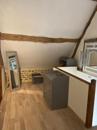 a room with a kitchen with a counter and a microwave at Gite Des Roses in Le Grais