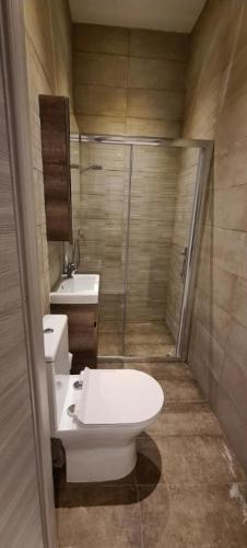 a bathroom with a toilet and a shower and a sink at Highly finished Studio Home in Valletta in Valletta