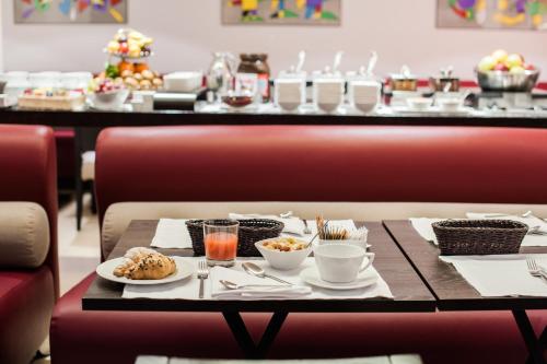 a table with food on it in a restaurant at Hotel Casa Poli in Mantova