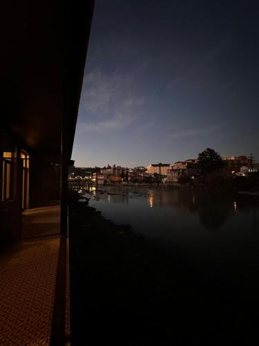 a view of a body of water at night at Apartment Riverside in Kutaisi
