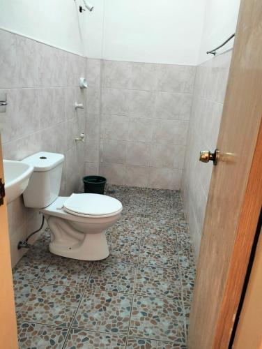 a bathroom with a toilet and a sink at The Sylvia in San Juan