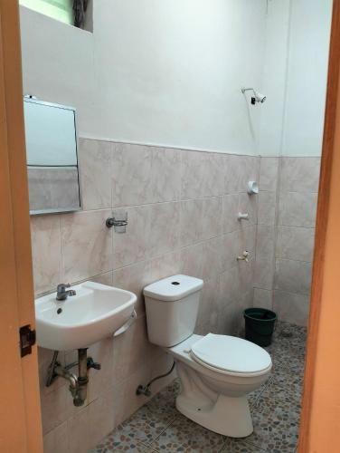 a bathroom with a toilet and a sink at The Sylvia in San Juan
