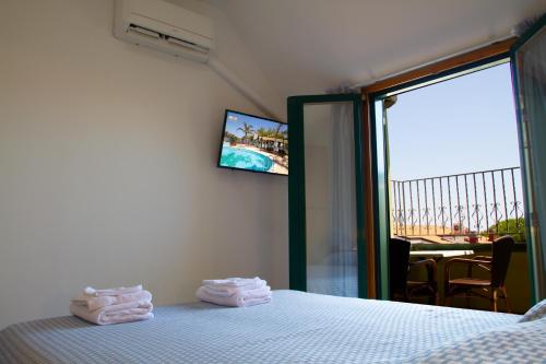 a bedroom with a bed with folded towels on it at Residence Playa in Tortoreto Lido