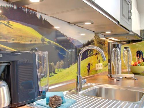 a kitchen with a sink and a painting on the wall at Grub-Daniel-Hof in Freiamt
