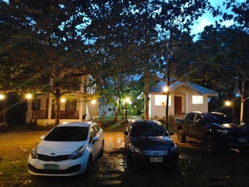 two cars parked in front of a house at night at The Sylvia in San Juan