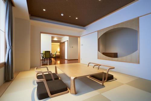a dining room with a table and chairs at Tendo Hotel in Tendo