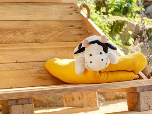 a stuffed cow sitting in a yellow raft at Grub-Daniel-Hof in Freiamt
