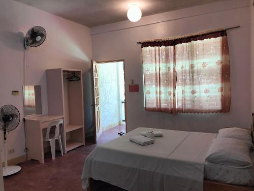 a bedroom with a bed and a desk and a window at The Sylvia in San Juan