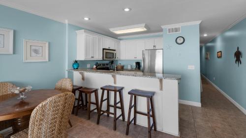 a kitchen with a bar and a table and chairs at Mistral 10 in Seacrest