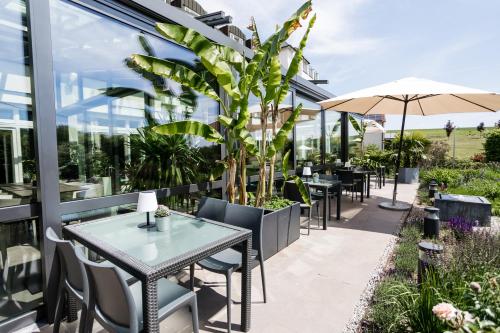 a patio with tables and chairs on a building at Landhotel Rügheim in Rügheim