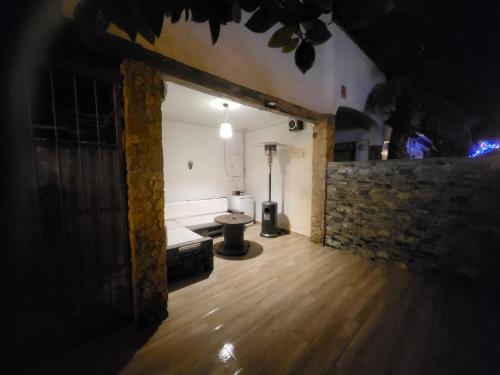 an empty room with a couch and a brick wall at Can Kuqueta, Platja d'Aro in Platja  d'Aro