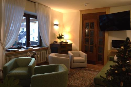 a living room with a christmas tree in a room at Hotel Wanda in Pinzolo