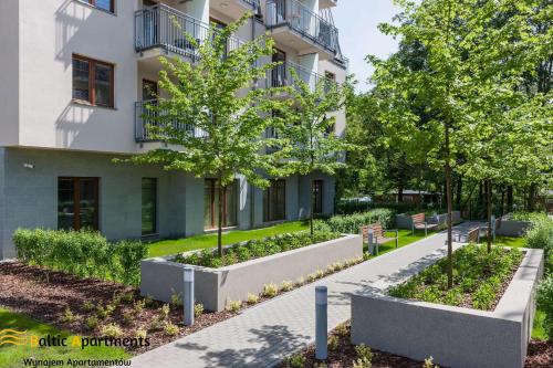 a building with trees in front of it at Baltic Apartments - Apartamenty Aquamarina in Świnoujście