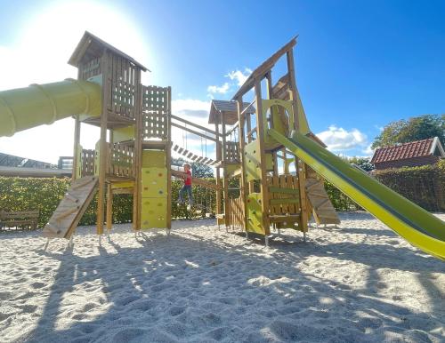 a playground with a slide on the beach at Vakantiepark de Witte Berg in Ootmarsum