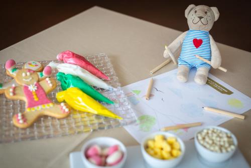 a table topped with a teddy bear and some toys at EPIC SANA Lisboa Hotel in Lisbon